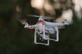 14 - White drone carrying a camera on a gimbal looks left