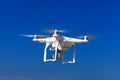 White drone with hovering with blue sky