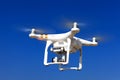 White drone with hovering with blue sky