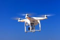 White drone with hovering with blue sky