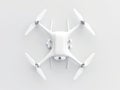 White drone hovers against white background