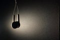 White earphone with brown light on dark background Royalty Free Stock Photo