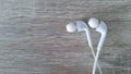 White earphone on wooden background Royalty Free Stock Photo