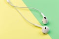 White earphones on colour background Royalty Free Stock Photo