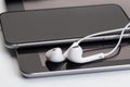 White earphones on tablet and phone Royalty Free Stock Photo