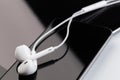 White earphones on tablet and phone Royalty Free Stock Photo