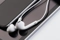 White earphones on tablet and phone Royalty Free Stock Photo