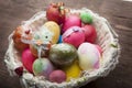 White easter basket with easter eggs on wooden background