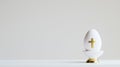 White Easter egg with gold cross on light studio light bavkground Royalty Free Stock Photo