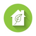 White Eco friendly house icon isolated with long shadow. Eco house with leaf. Green circle button. Vector Royalty Free Stock Photo