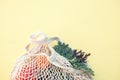 White eco-friendly textile string bag with fresh fruits, herbs and vegetables from local farmer market  on yellow backgrou Royalty Free Stock Photo