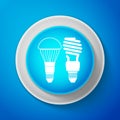 White Economical LED illuminated lightbulb and fluorescent light bulb icon isolated on blue background. Save energy lamp Royalty Free Stock Photo