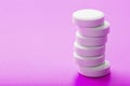 White Ecstasy pills in a row on a pink background, isolate. Royalty Free Stock Photo