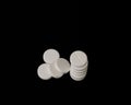 White effervescent tablets on black background