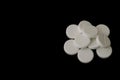 White effervescent tablets on black background