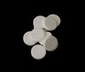 White effervescent tablets on black background