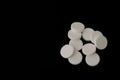 White effervescent tablets on black background