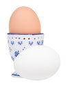 white egg and brown boiled egg in ceramic egg cup