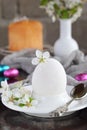 White egg and flowers on clay plate. Happy Easter card. Holidays breakfast concept. Festive table place setting decoration with Royalty Free Stock Photo