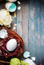 White egg in little nest with light flowers on wooden rustic background. Easter spring concept Royalty Free Stock Photo