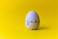 White egg timer on yellow background. Happy Easter in the kitchen. Home related, home staying. Free copy space Royalty Free Stock Photo