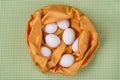 White eggs in an abstract nest of yellow textures, green background of tablecloths in the kitchen Royalty Free Stock Photo