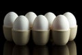 White eggs in egg-cups on black Royalty Free Stock Photo