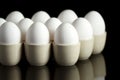 White eggs in egg-cups on black 2 Royalty Free Stock Photo