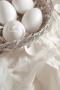 White eggs and feathers in a woven basket, symbolizing new beginnings. Ideal for Easter and spring themes. - AI Generated