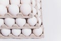 White eggs of a hen in harmless, cardboard packing on a white background. 3 packs. Royalty Free Stock Photo