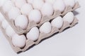 White eggs of a hen in harmless, cardboard packing on a white background. 2 packs. Royalty Free Stock Photo