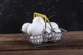 White eggs in an iron food basket on a wooden table Royalty Free Stock Photo