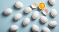 White Eggs and One Cracked Egg with Bright Yolk on Light Blue Background Royalty Free Stock Photo