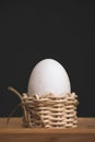 White eggs in small baskets and black background Royalty Free Stock Photo