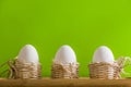 White eggs in small baskets and green background Royalty Free Stock Photo