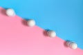 White eggs standing on egg cup on blue and pink pastel background, copy space. Row of boiled egg in stand on paper background Royalty Free Stock Photo