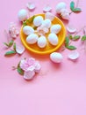 White Eggs on Yellow plate flowers On Pink Background Ester Holiday Background Concept