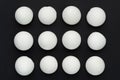 White eggshells are laid out in even rows on a black background. The concept of sameness, equality and equity. The concept of Royalty Free Stock Photo