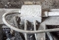 White electric box with three black cables on the old red brick wall. Royalty Free Stock Photo