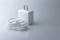 White electric charging with USB cable for phone on gray background Royalty Free Stock Photo