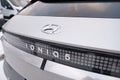 white electric crossover Hyundai IONIQ 5, Logo on cap, trends EV in Europe, technological advancements automotive industry,