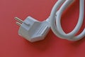 White electric euro plug on red background Royalty Free Stock Photo