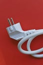 White electric euro plug on red background Royalty Free Stock Photo