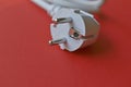 White electric euro plug on red background Royalty Free Stock Photo