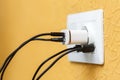 White electric plug with built in usb ports and usb charger with multiple black and white cords Royalty Free Stock Photo