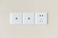 white electric plugs or outlet on wall, with tv and tel