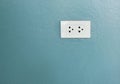 White electric power outlet on home cement wall