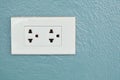 White electric power outlet on home cement wall