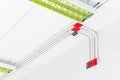 White electric PVC pipe in red and black are connected to power lines or electrical wires, Ethernet UTP cables, internet and light