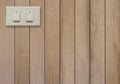 White electric switch on brown wooden wall. Royalty Free Stock Photo